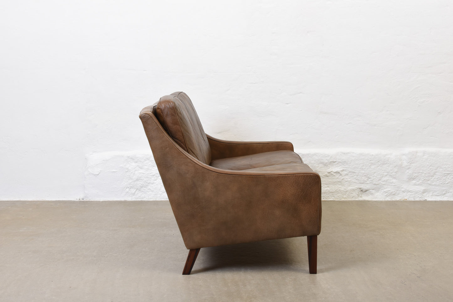 1960s two seat leather sofa on rosewood legs