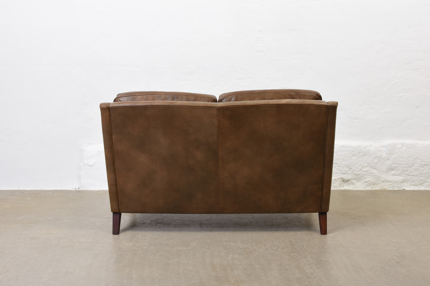 1960s two seat leather sofa on rosewood legs