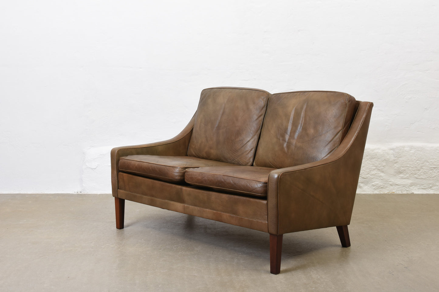 1960s two seat leather sofa on rosewood legs