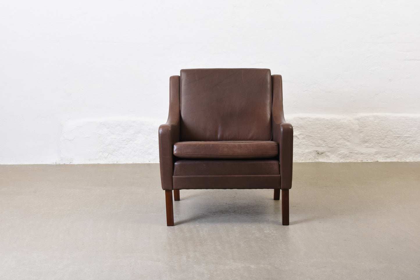 1960s leather club chair on rosewood legs