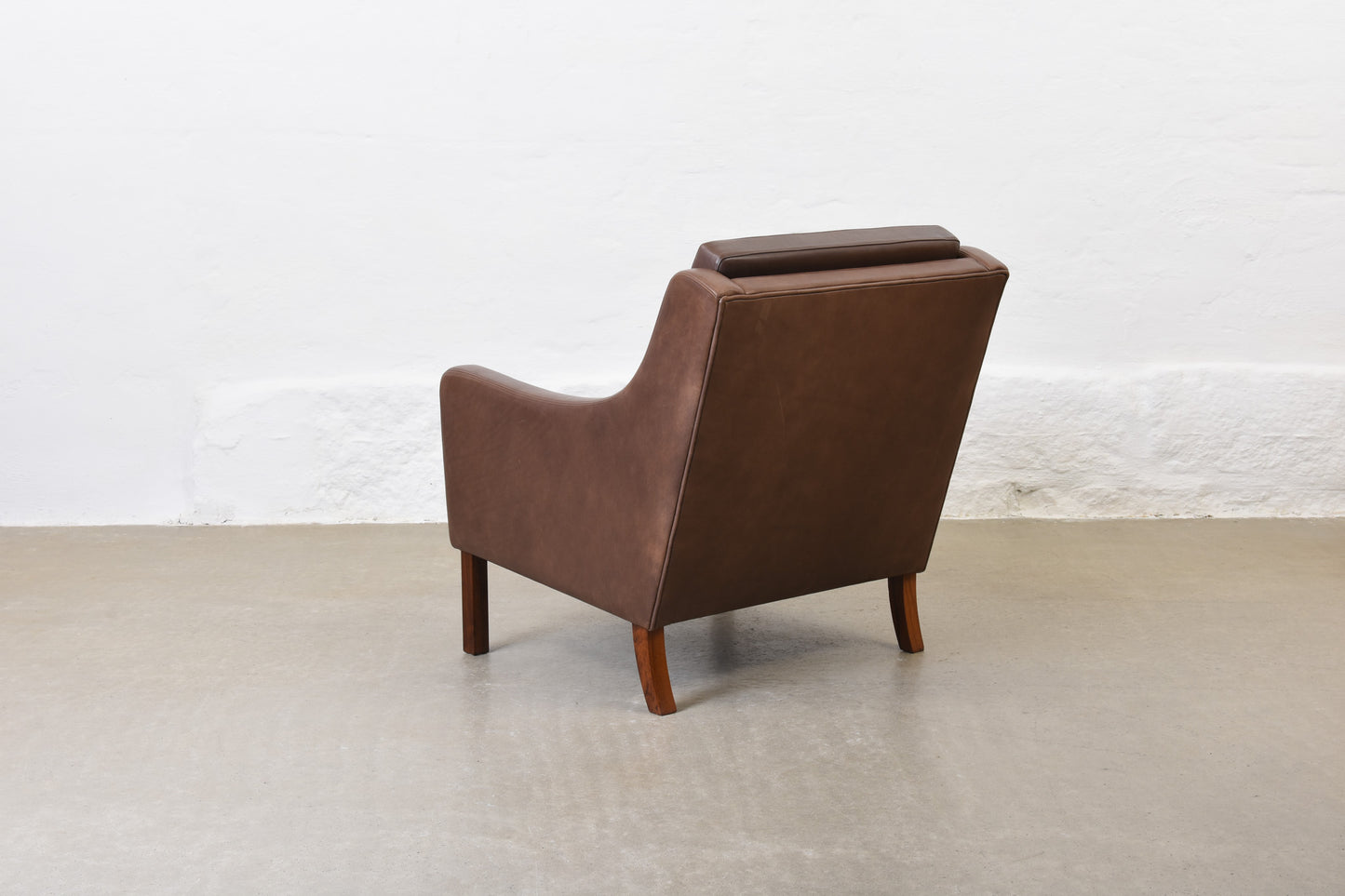 1960s leather club chair on rosewood legs