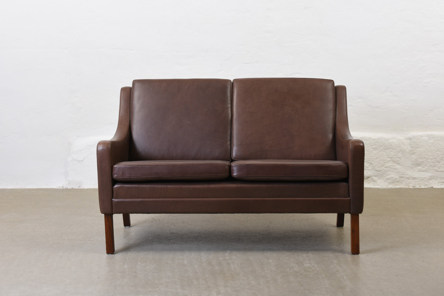 1960s two seat leather sofa on rosewood legs