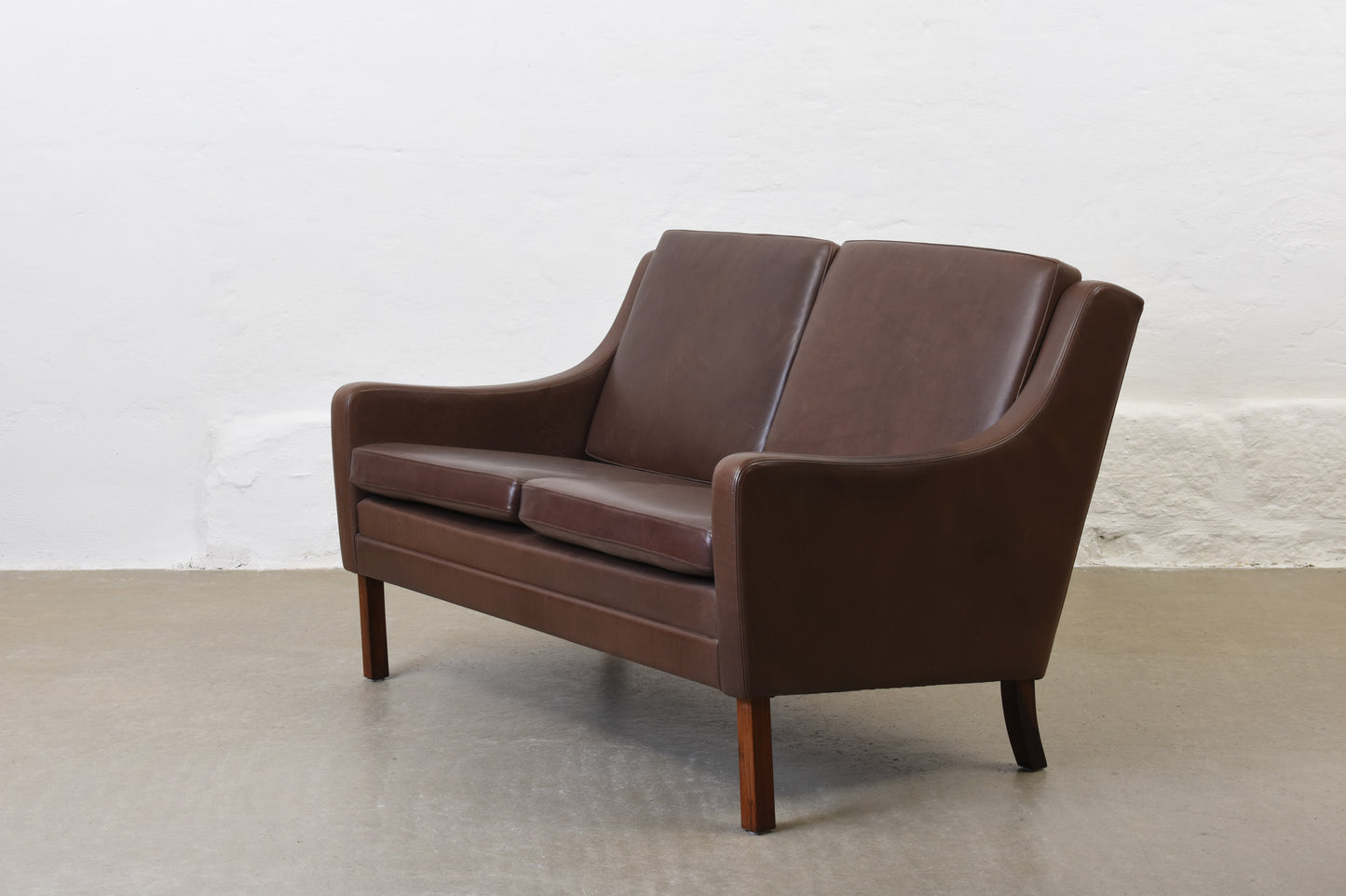 1960s two seat leather sofa on rosewood legs