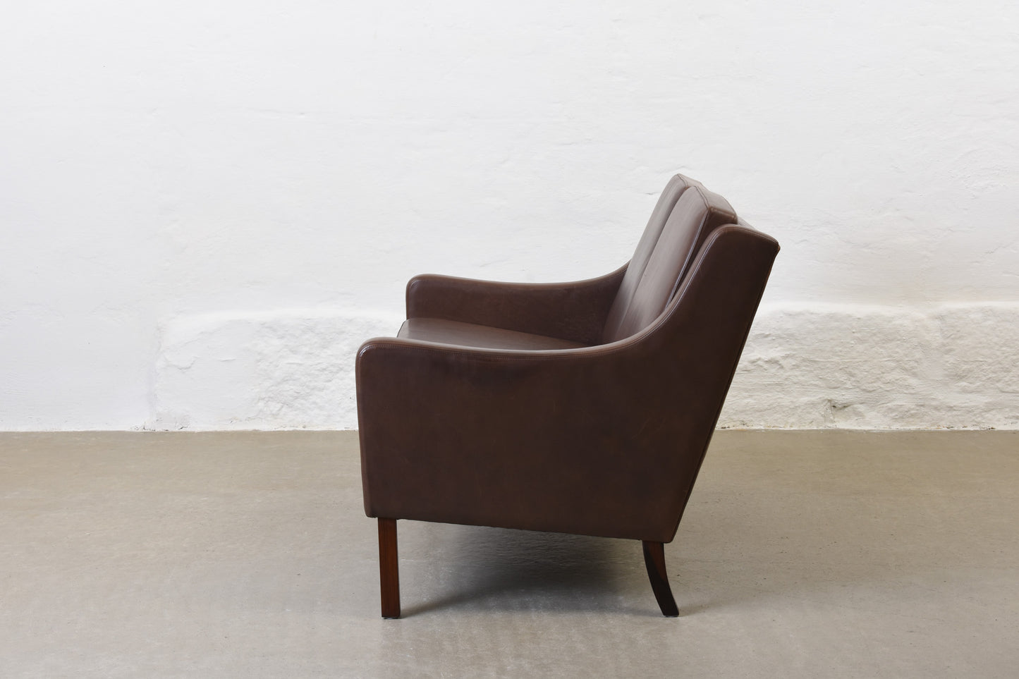 1960s two seat leather sofa on rosewood legs