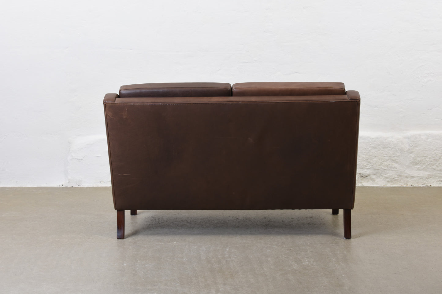 1960s two seat leather sofa on rosewood legs