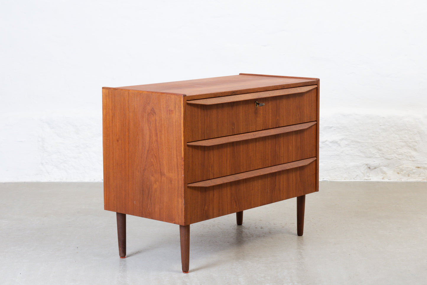 1960s low teak chest of three drawers