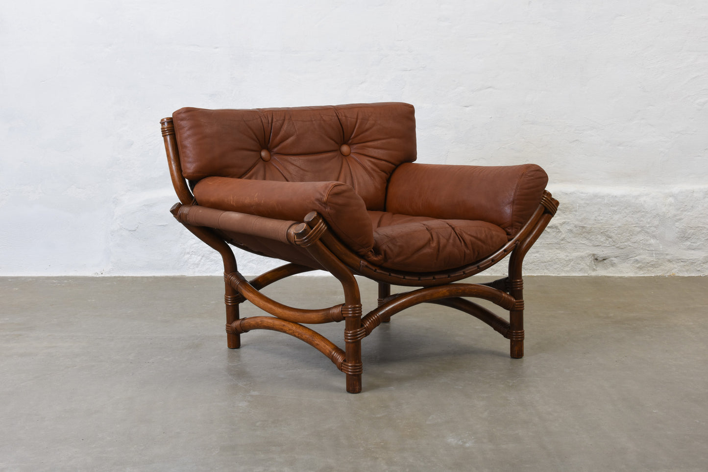 Two available: 1970s bamboo + leather lounge chairs