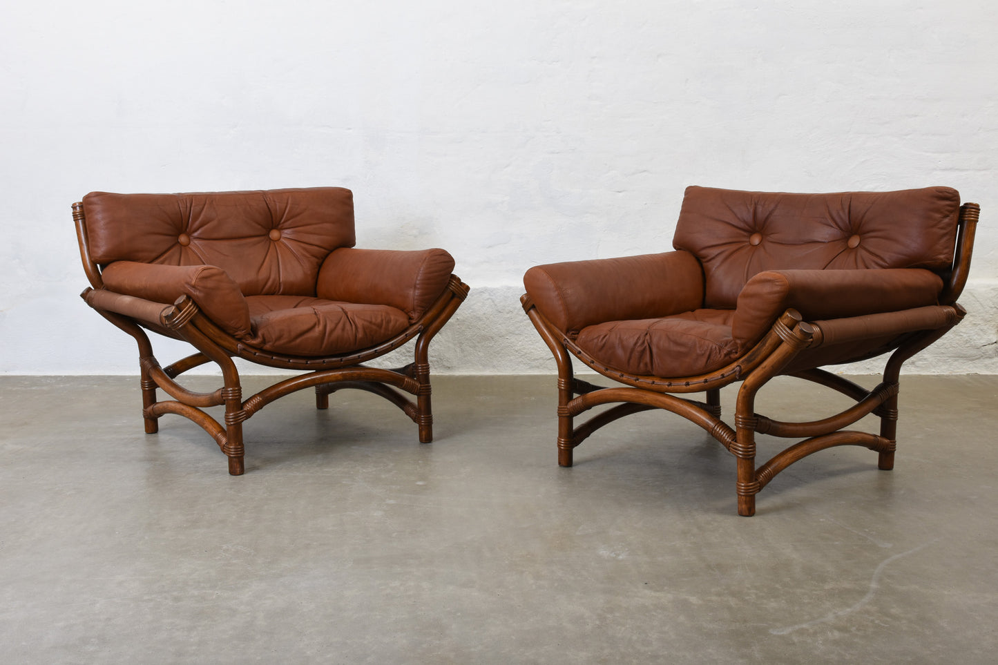 Two available: 1970s bamboo + leather lounge chairs