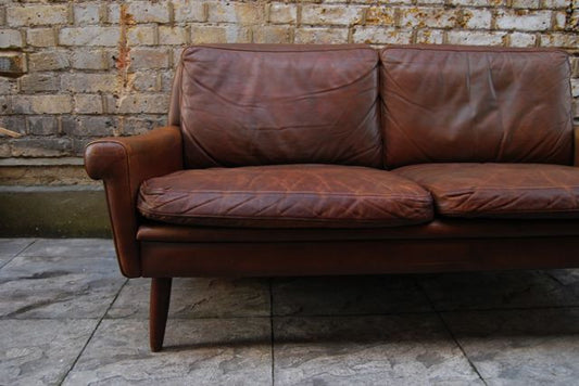 Two seat leather sofa by Skipper