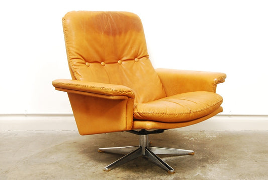 Tan leather lounger on swivel base