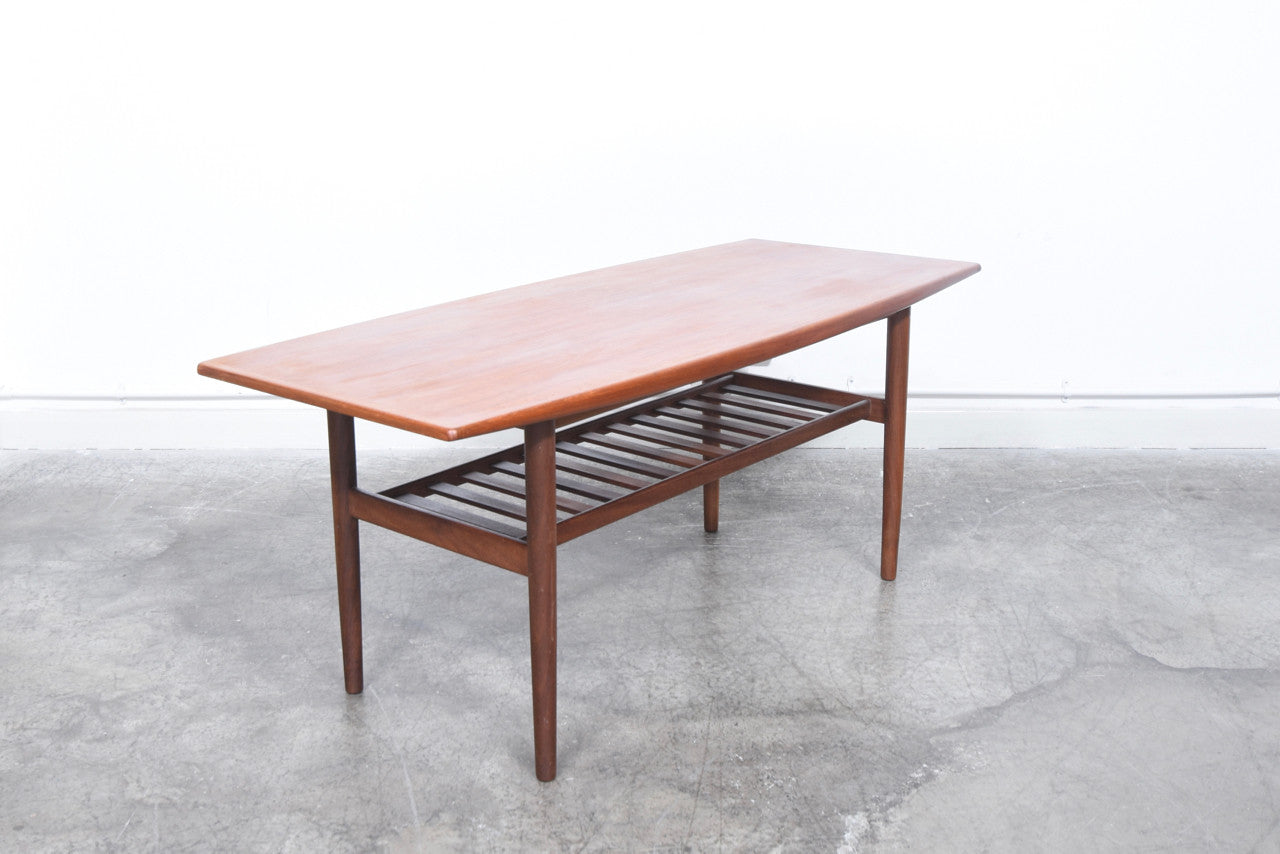 Teak coffee table with slatted magazine shelf