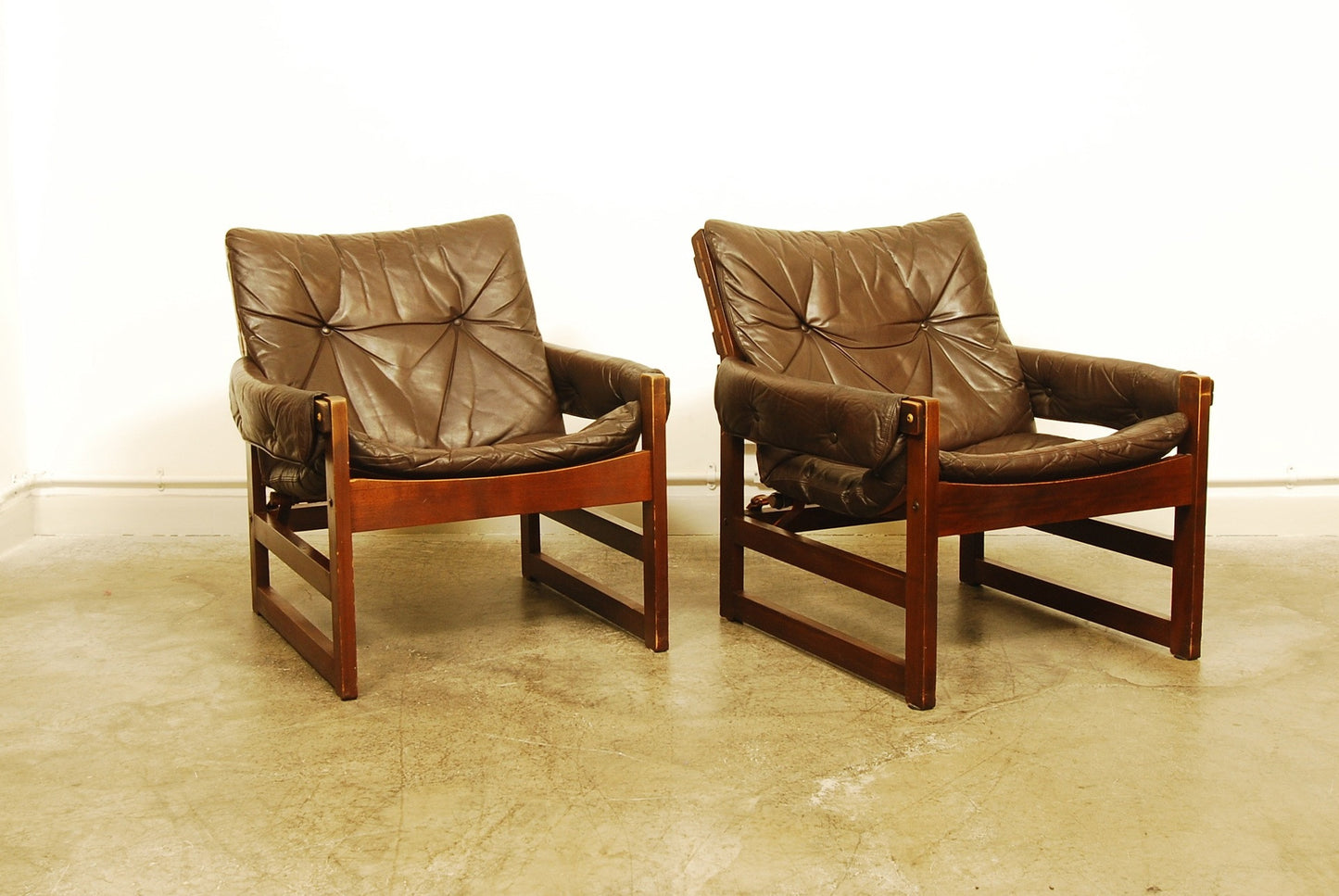Pair of stained beech lounge chairs