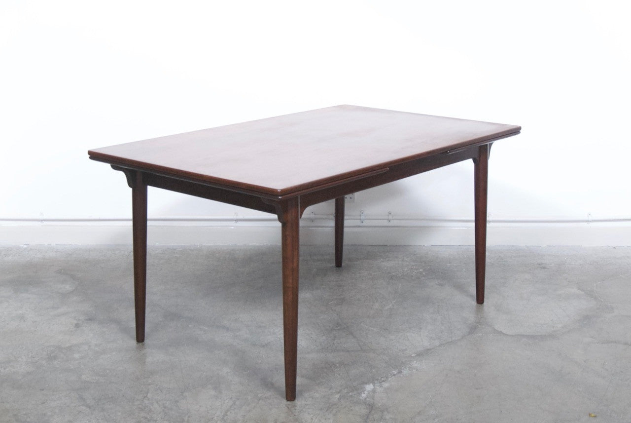 Extending rosewood dining table by Omann Junior