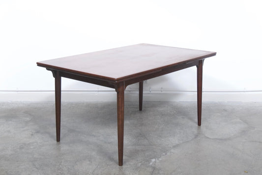 Extending rosewood dining table by Omann Junior