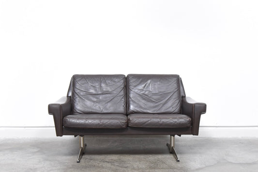 Two seat sofa in leather on shaker legs