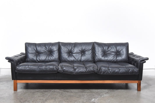 Black leather three seat sofa