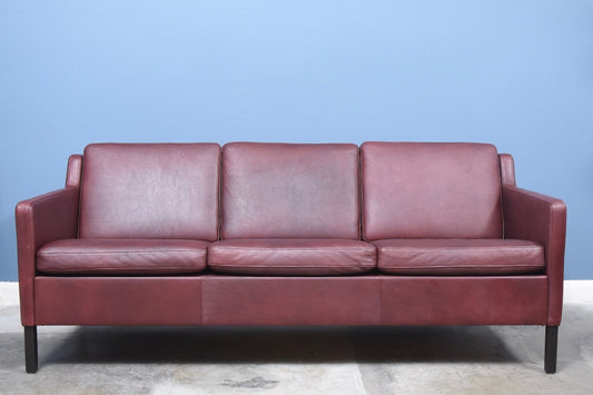 Three seat sofa in maroon leather