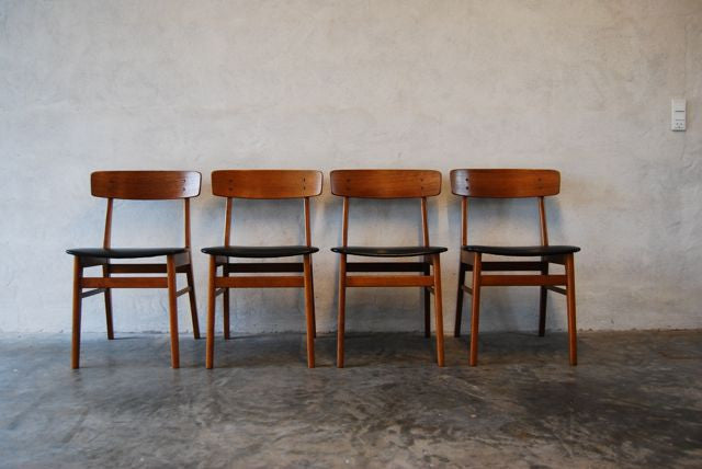Set of four dining chairs in teak and leatherette