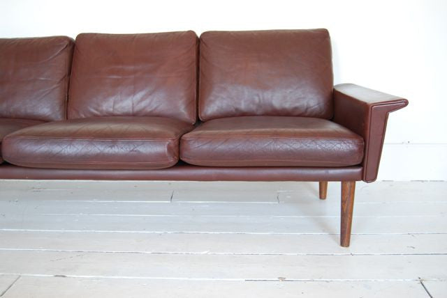 Three seat leather sofa with rosewood legs
