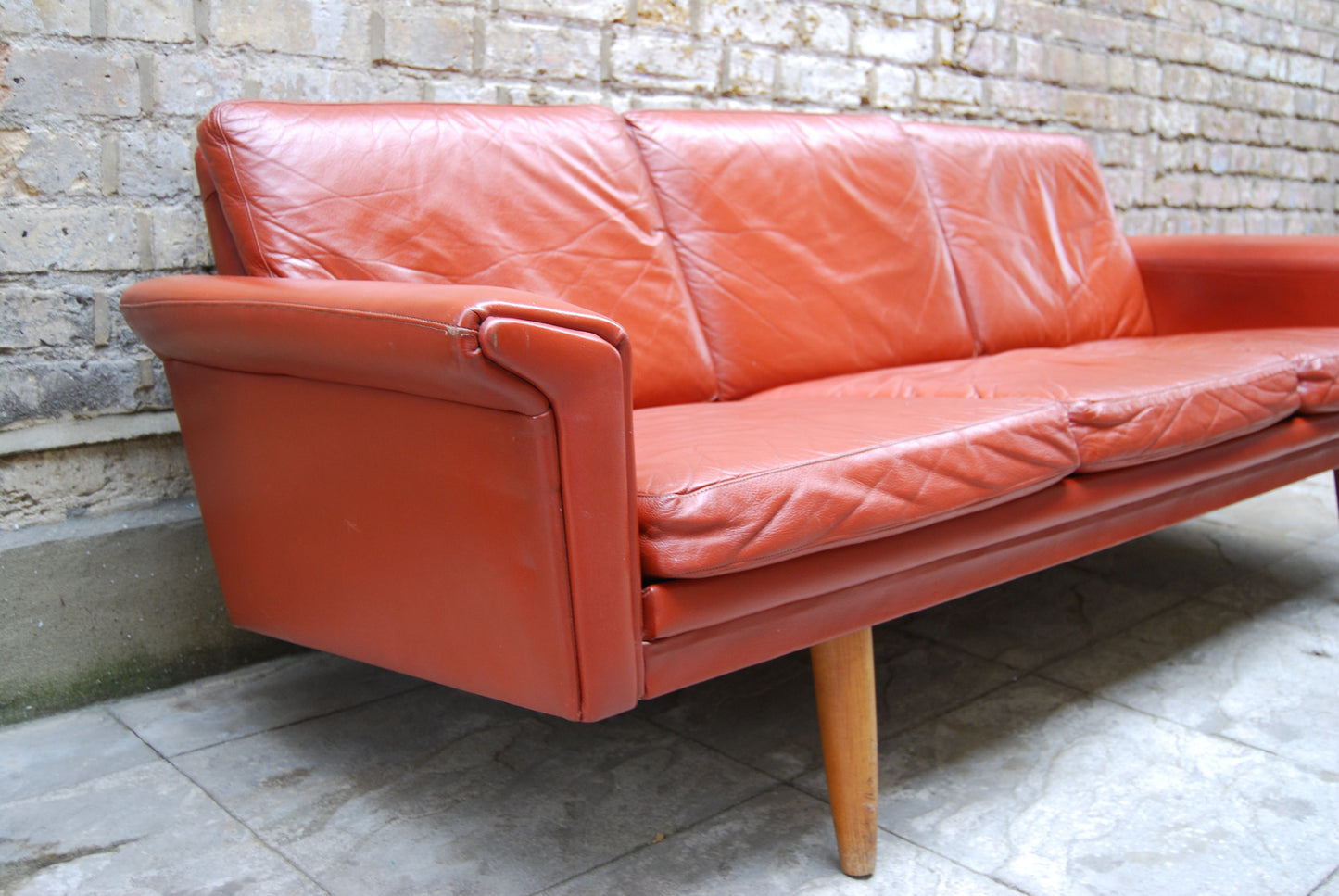 Three seat red leather sofa