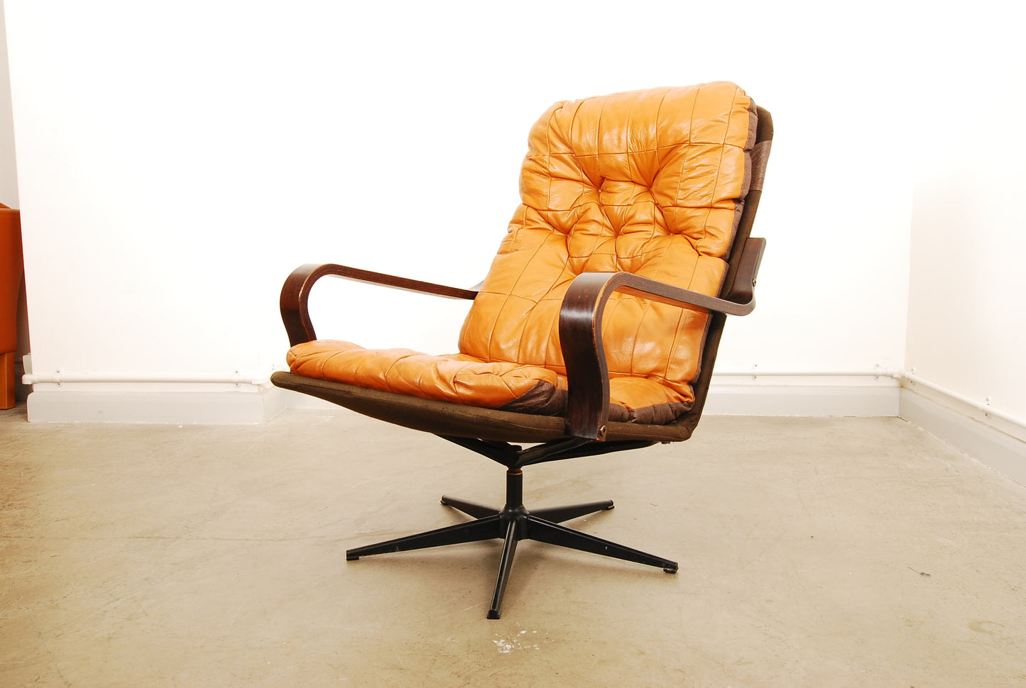 Leather lounge chair on swivel base