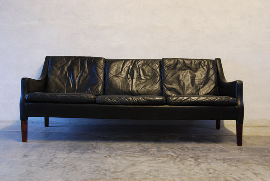 Three seat sofa in jet black leather