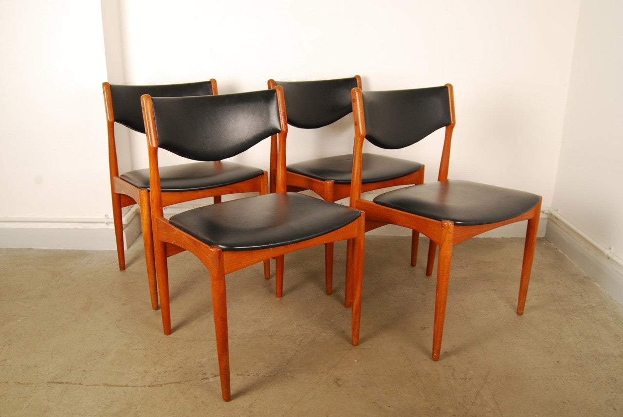 Set of four teak and leatherette dining chairs