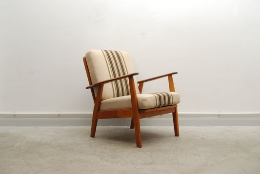 Teak lounge chair with striped cushions