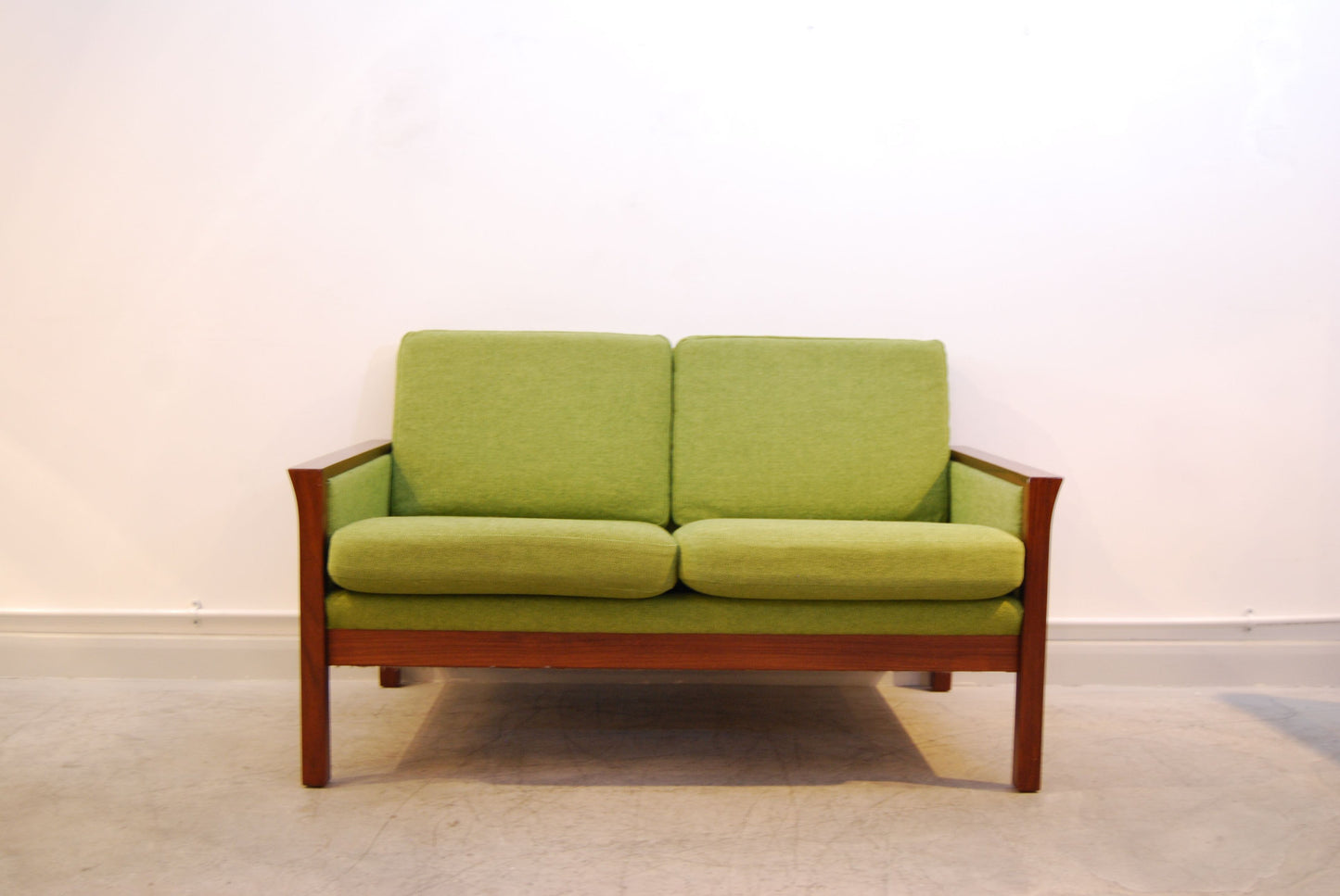 Grass green and teak two seat sofa