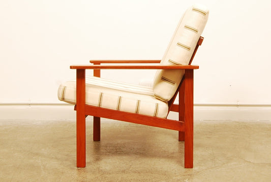 Teak lounge chair with cream cushions