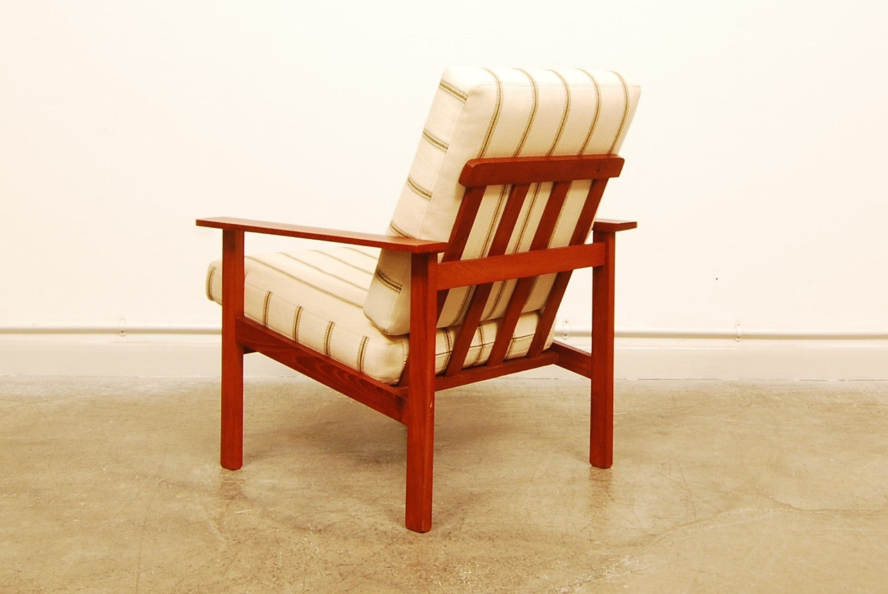 Teak lounge chair with cream cushions