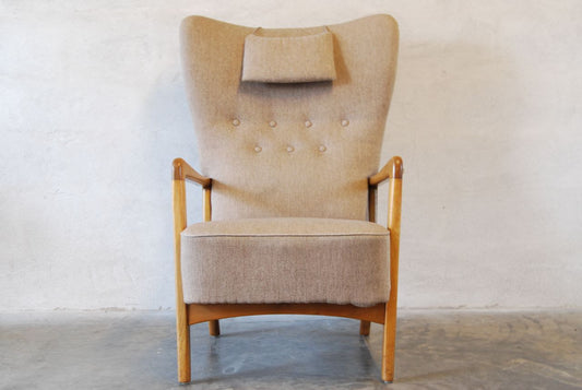 Wingback chair with grey upholstery