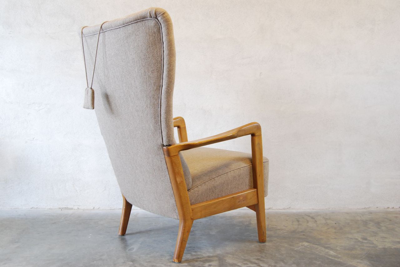Wingback chair with grey upholstery