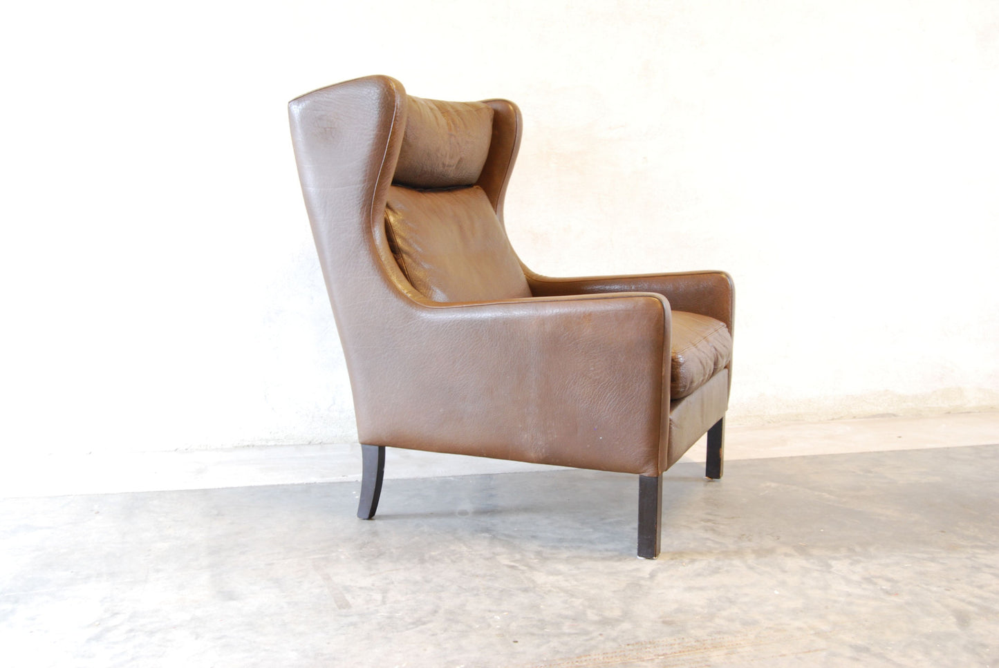 Wingback lounge chair in buffalo leather