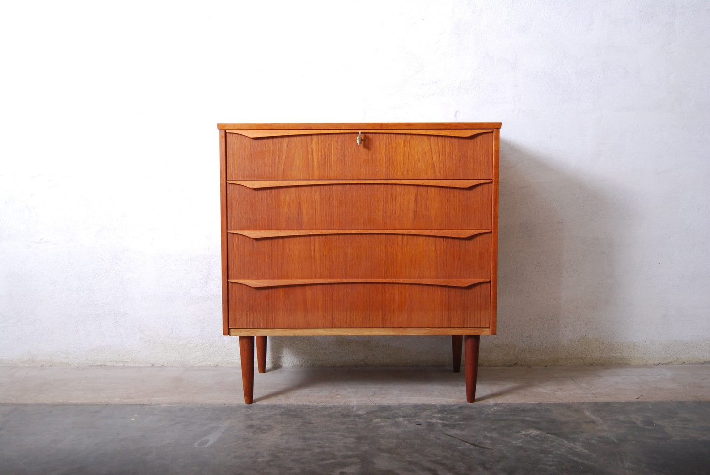 Short chest of four drawers with lipped handles