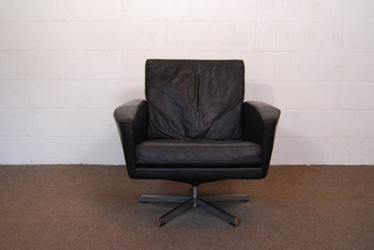 Black leather low back lounger on swivel base