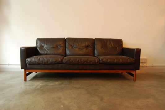 Three seat leather sofa on rosewood base