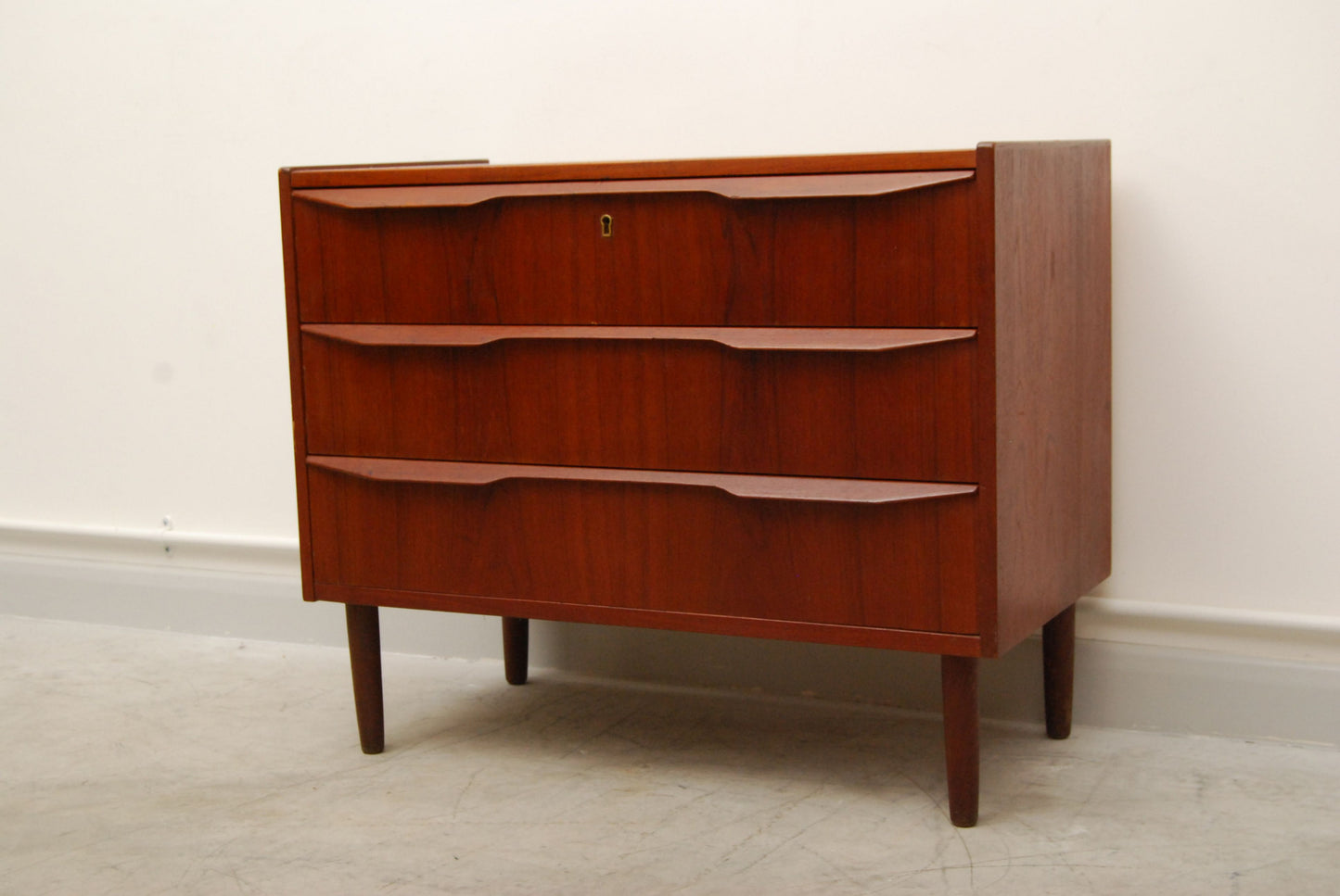 Chest of three drawers with lipped handles