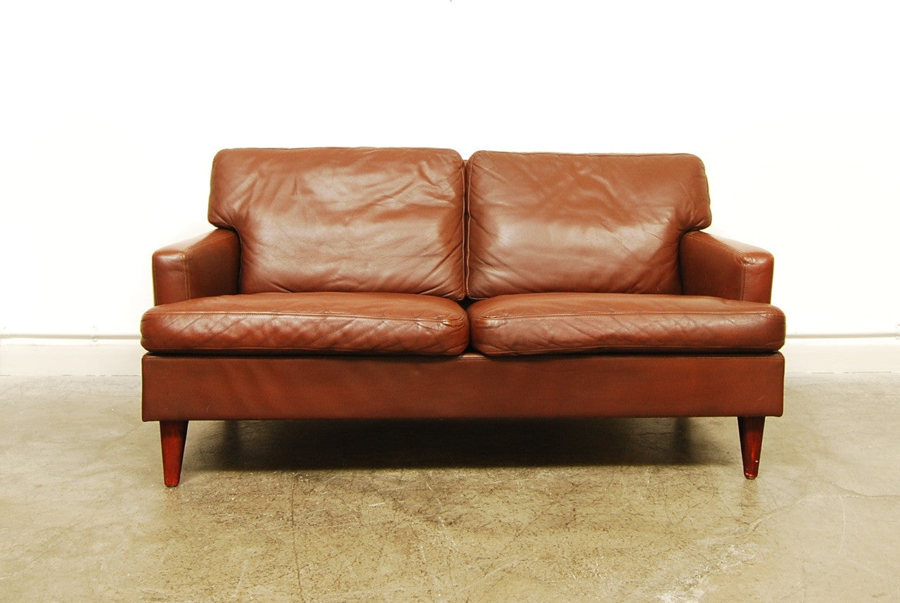 Two seat brown leather sofa