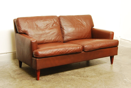 Two seat brown leather sofa