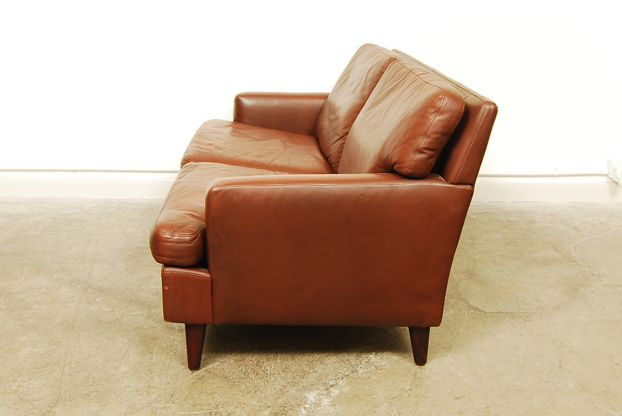 Two seat brown leather sofa