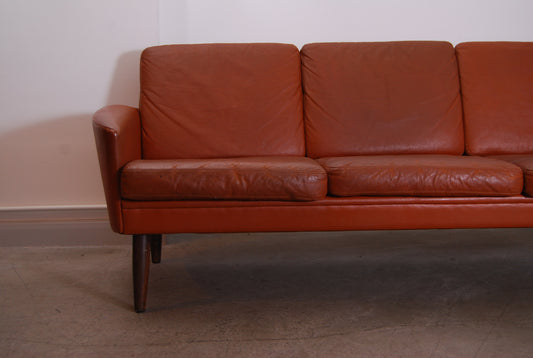 Three seat leather sofa on teak legs