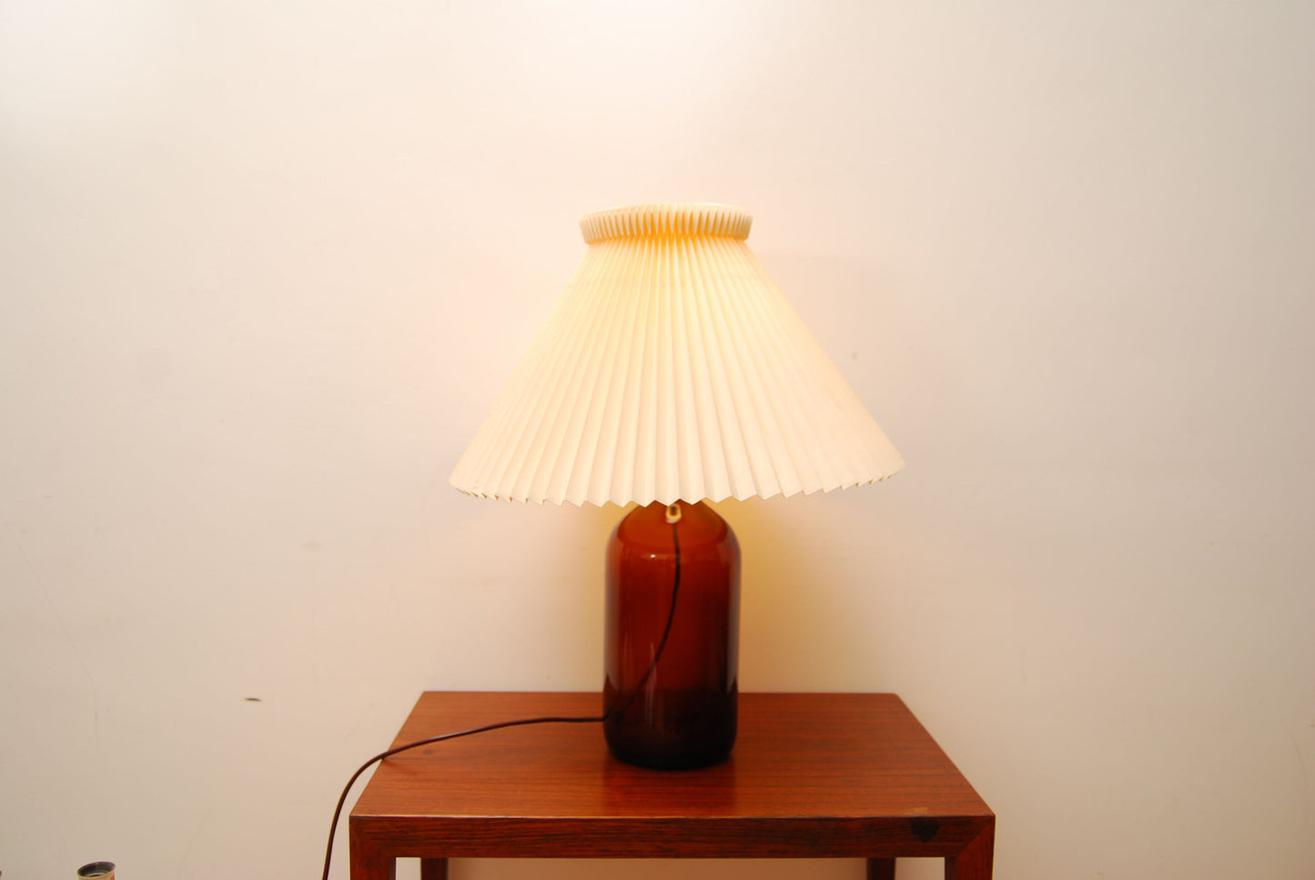 Glass bottle lamp with Le Klint shade