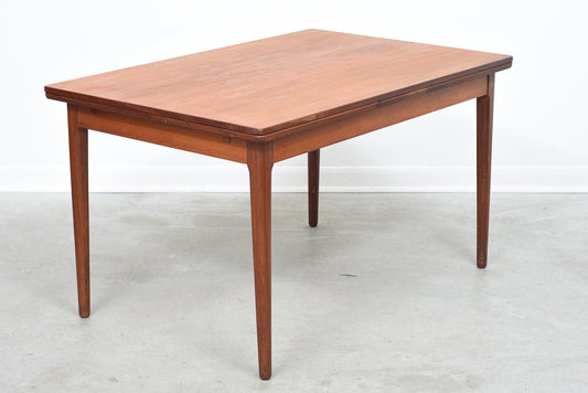 Extending teak dining table