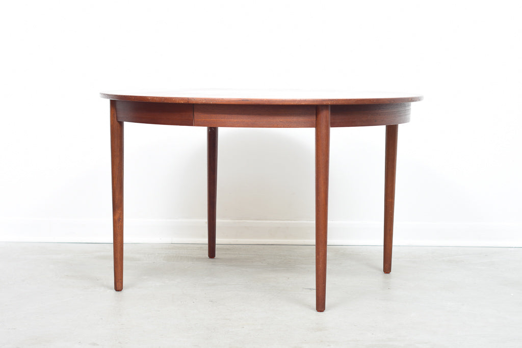 Extending round dining table in teak