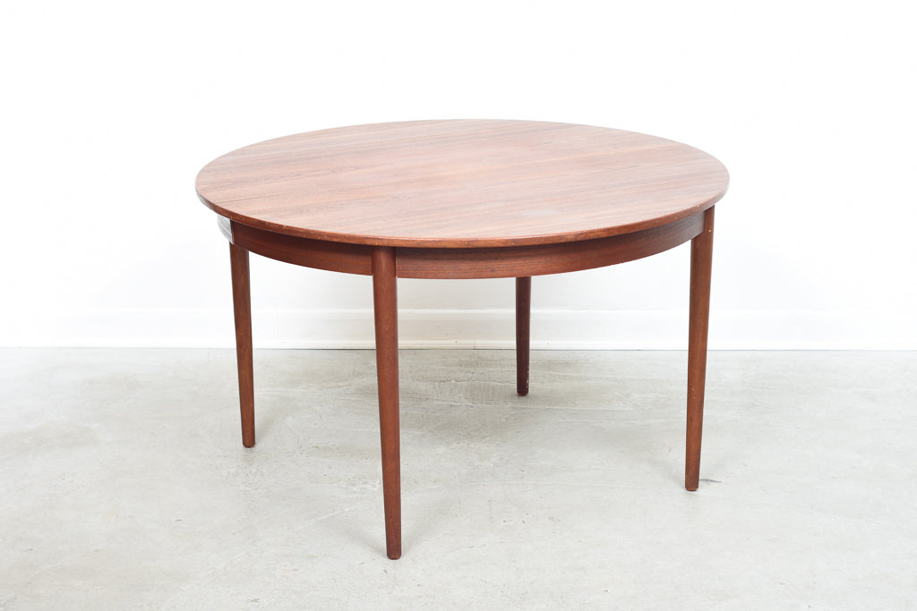 Extending round dining table in teak