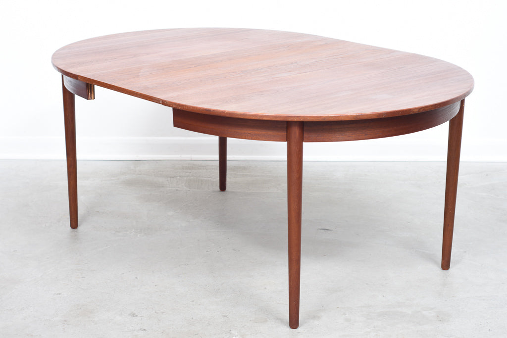 Extending round dining table in teak