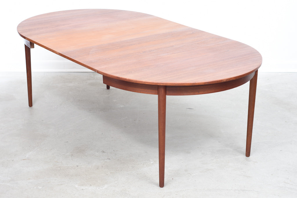 Extending round dining table in teak