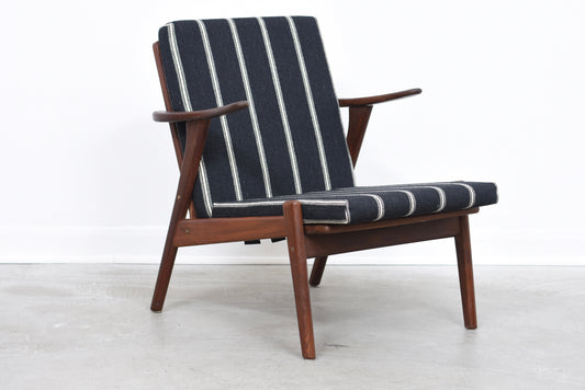 Teak lounge chair with striped cushions