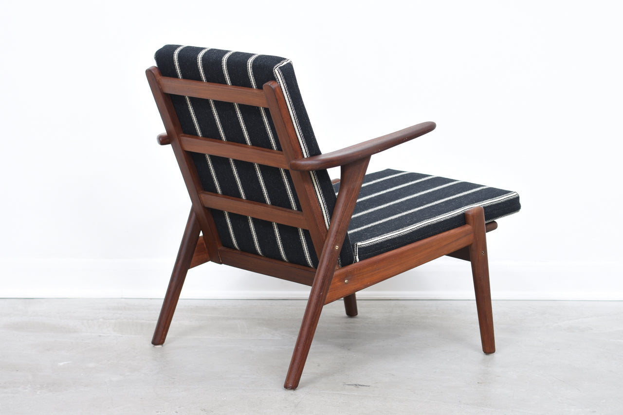 Teak lounge chair with striped cushions